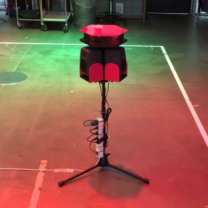 EMMA in full view. The hexagonal sound sculpture is mounted on a tripod and configured for multi-participant interaction in physical space. Each of the six sides functions as an interactive musical voice, allowing the sonic texture to grow in complexity as more participants engage with the system.